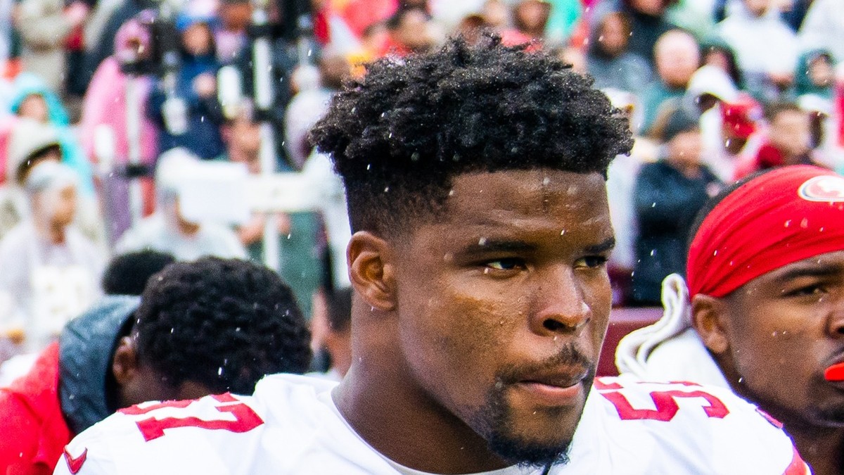 Dre Greenlaw in a white 49ers jersey on the sideline