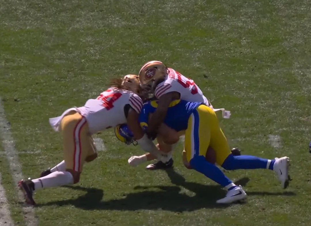 Fred Warner and Dre Greenlaw of the San Francisco 49ers combine on a tackle against the Los Angeles Rams