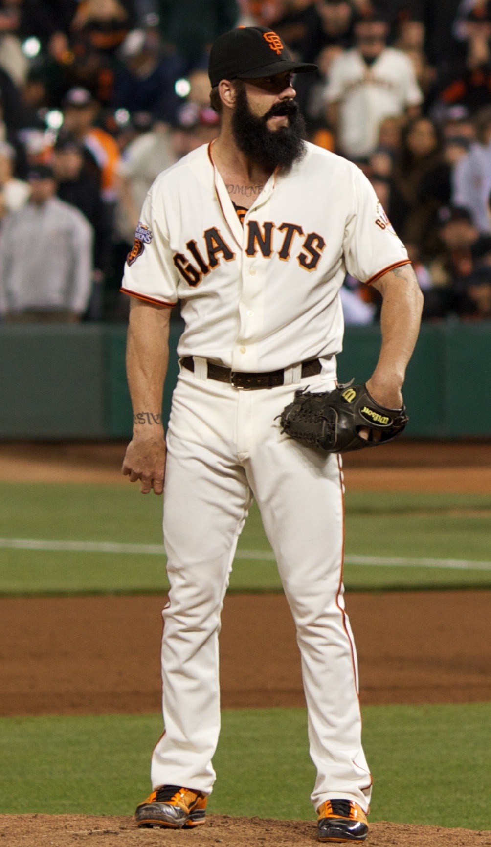 Brian Wilson in the Giants home white uniform with his full black beard, standing on the mound at AT&T Park