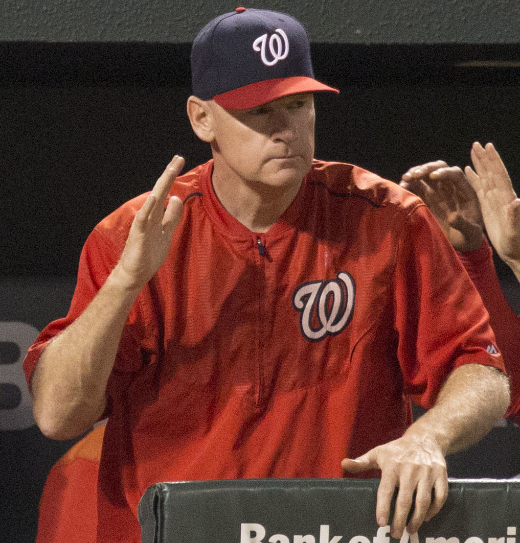Matt Williams in a Washington Nationals jacket and cap at the dugout rail in 2015
