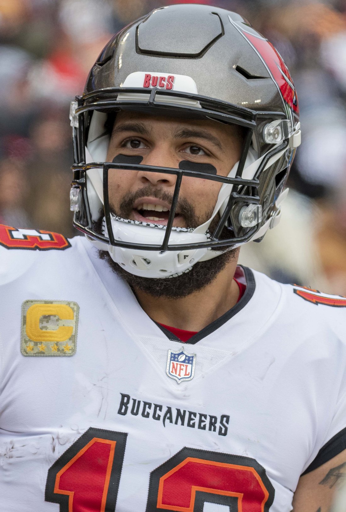 Mike Evans smiling on the field in his Tampa Bay Buccaneers uniform